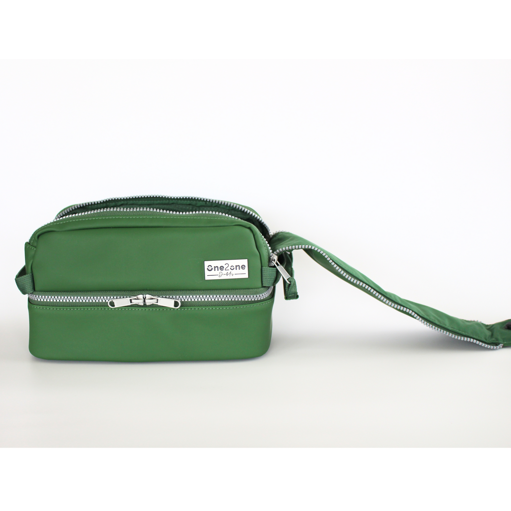 Green diabetes travel bag with large tongue zipper open on top on a light gray background