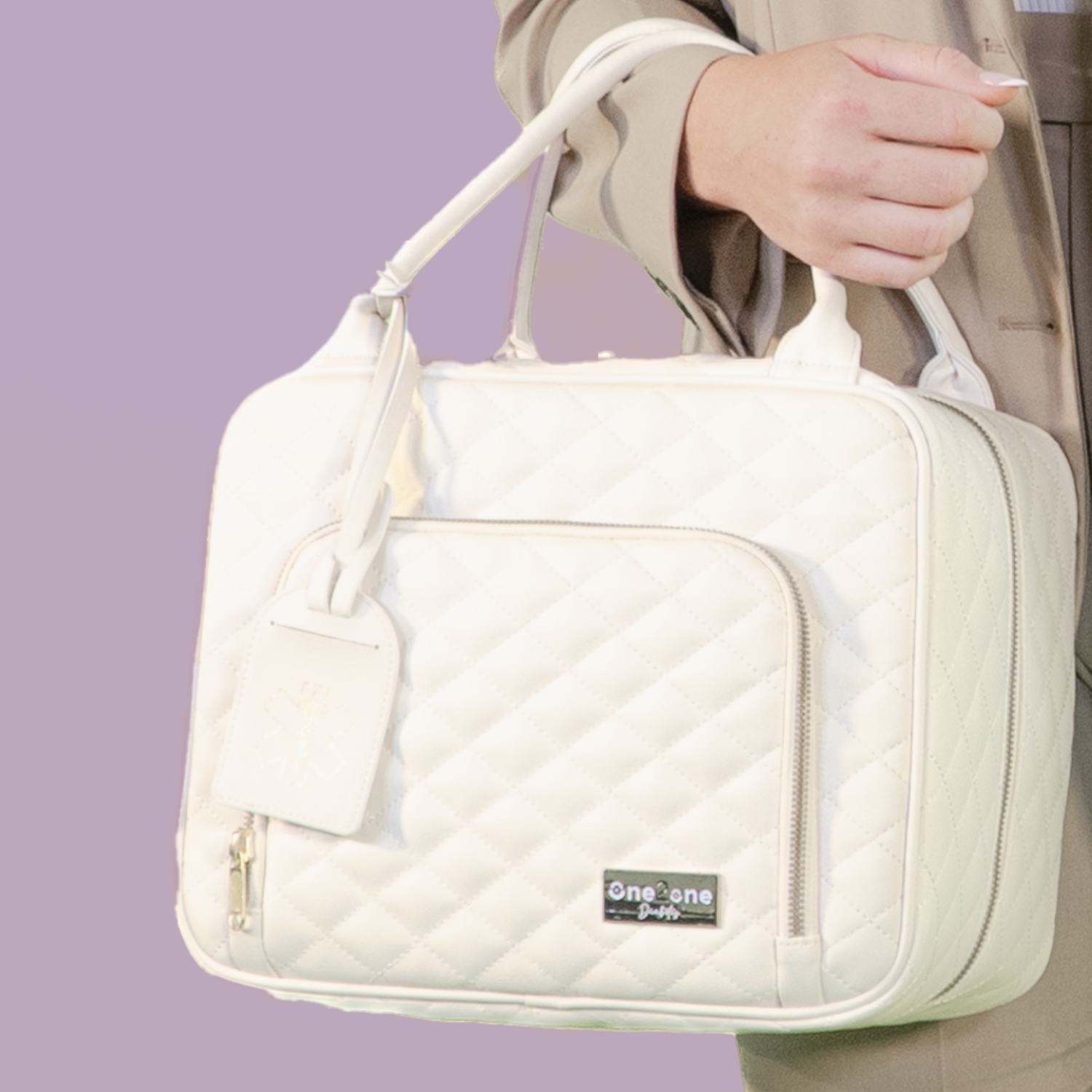Close up of a woman holding a large white diabetes travel bag with a purple background.