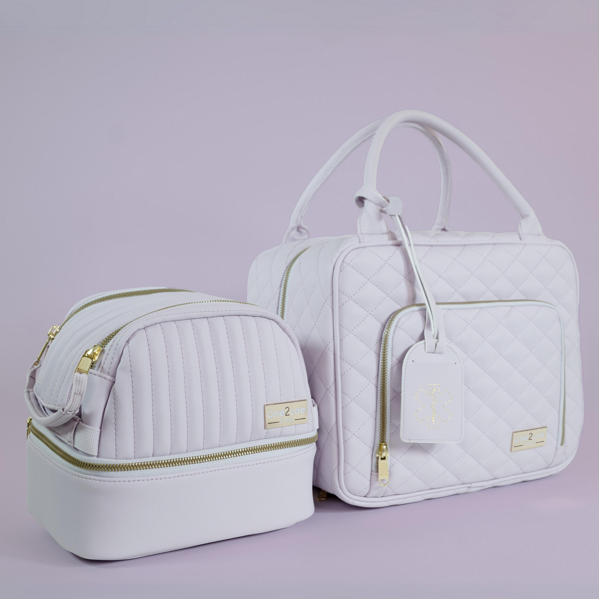 A small lavender diabetes travel bag next to a large lavender diabetes travel bag on a purple background.