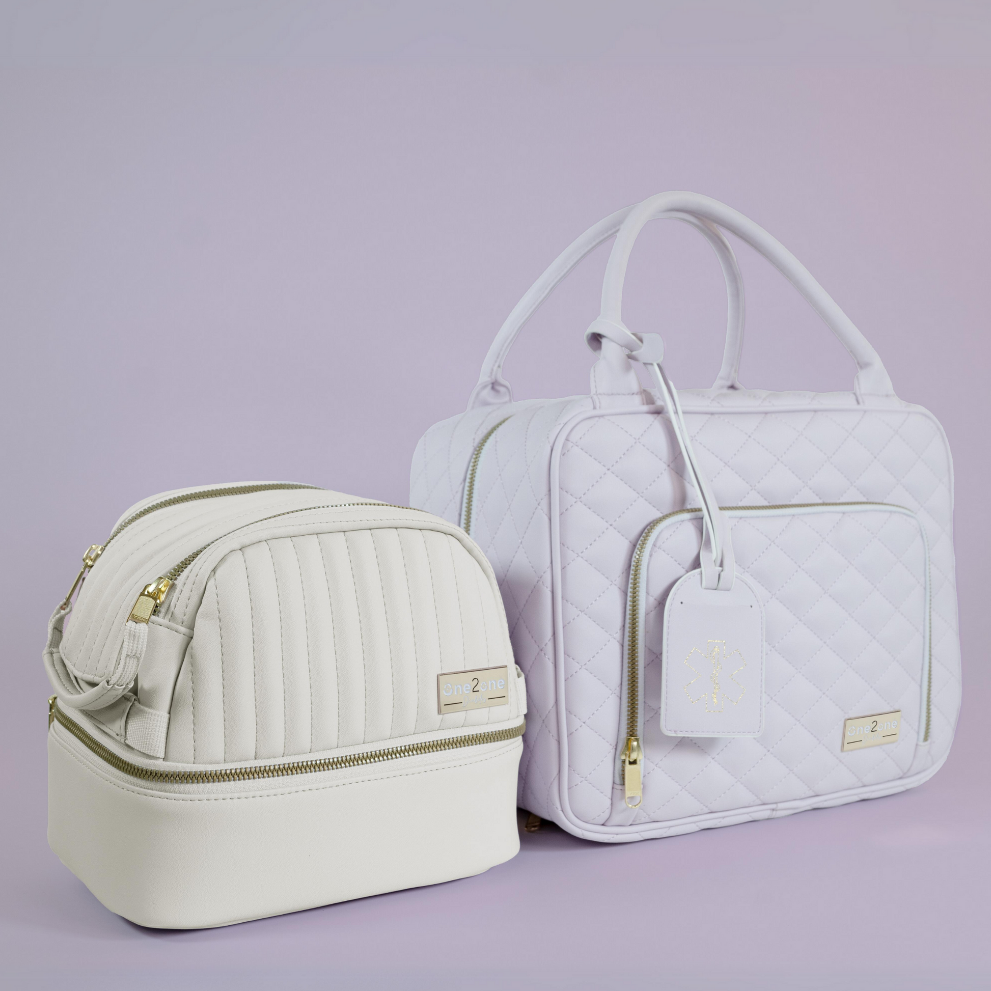 A small white diabetes travel bag next to a large lavender diabetes travel bag on a purple background.